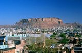 Jodhpur was founded in 1459 by Rao Jodha, a Rajput chief of the Rathore clan. Jodha succeeded in conquering the surrounding territory and thus founded a state which came to be known as Marwar. As Jodha hailed from the nearby town of Mandore, that town initially served as the capital of this state; however, Jodhpur soon took over that role, even during the lifetime of Jodha. The city was located on the strategic road linking Delhi to Gujarat. This enabled it to profit from a flourishing trade in opium, copper, silk, sandals, date palms and coffee.<br/><br/>

Early in its history, the state became a fief under the Mughal Empire, owing fealty to them while enjoying some internal autonomy. During this period, the state furnished the Mughals with several notable generals such as Maharaja Jaswant Singh. Jodhpur and its people benefited from this exposure to the wider world: new styles of art and architecture made their appearance and opportunities opened up for local tradesmen to make their mark across northern India.<br/><br/>

During the British Raj, the state of Jodhpur had the largest land area of any in Rajputana. Jodhpur prospered under the peace and stability that were a hallmark of this era. Its merchants, the Marwaris, flourished and came to occupy a position of dominance in trade across India. In 1947, when India became independent, the state merged into the union of India and Jodhpur became the second city of Rajasthan.